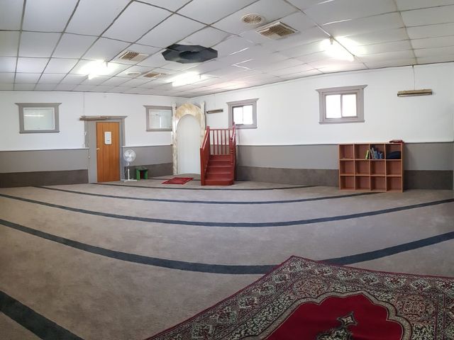 Wide view of the carpeted prayer hall